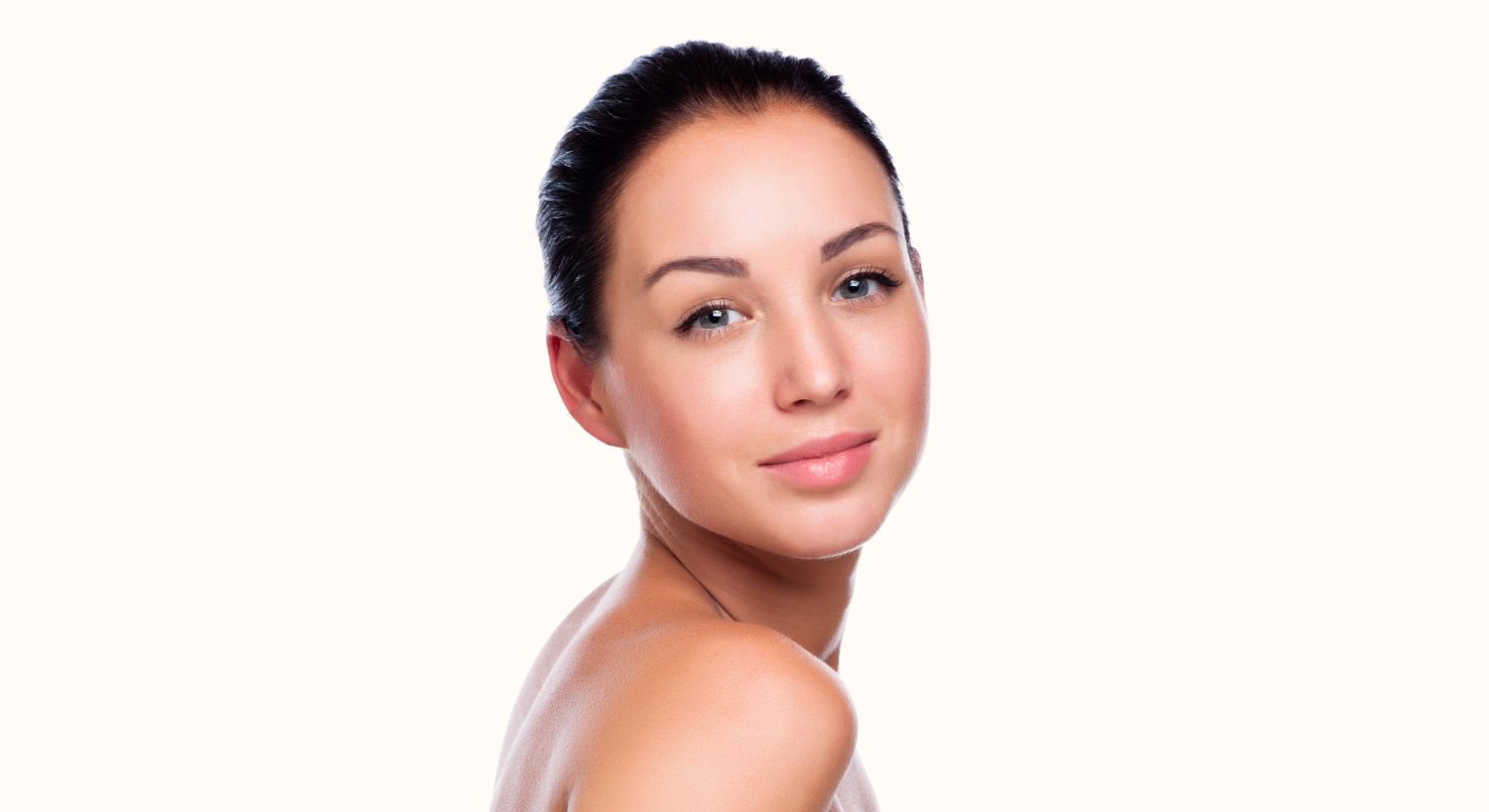 Profile portrait of a woman in soft lighting.