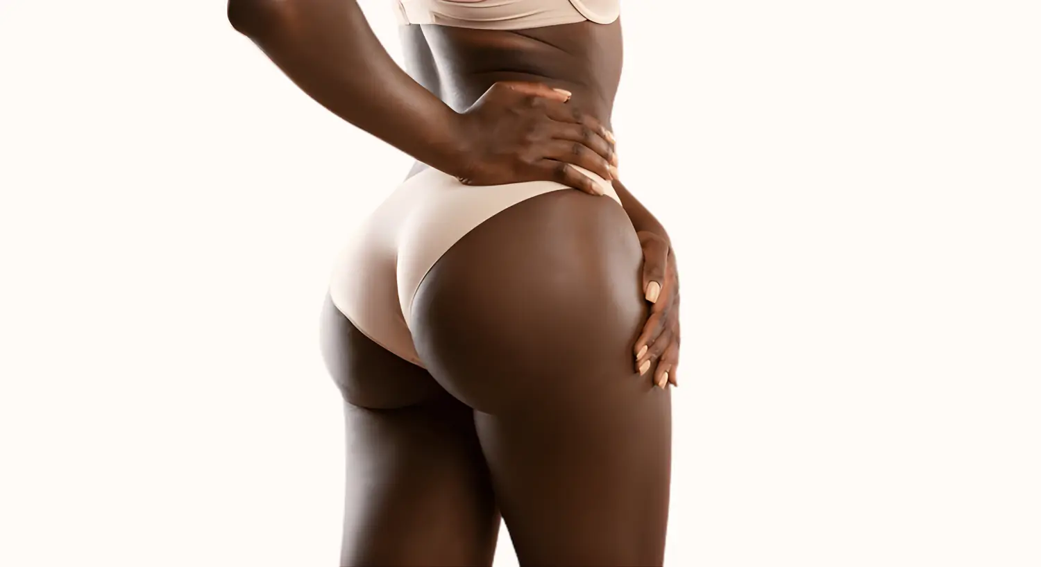 Model in black shorts showcasing fitness and shape.