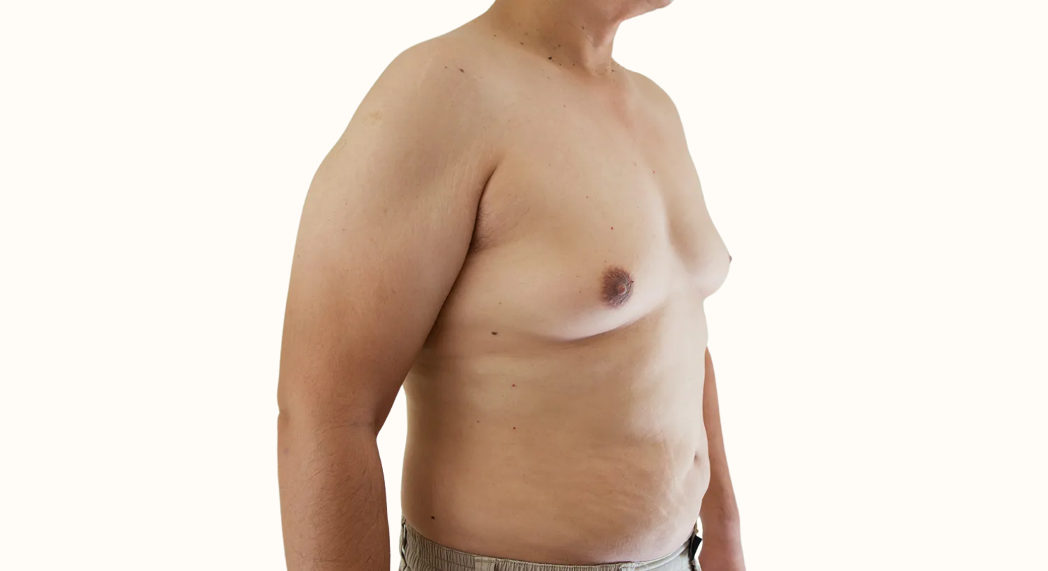 Shirtless man listening to music on balcony.
