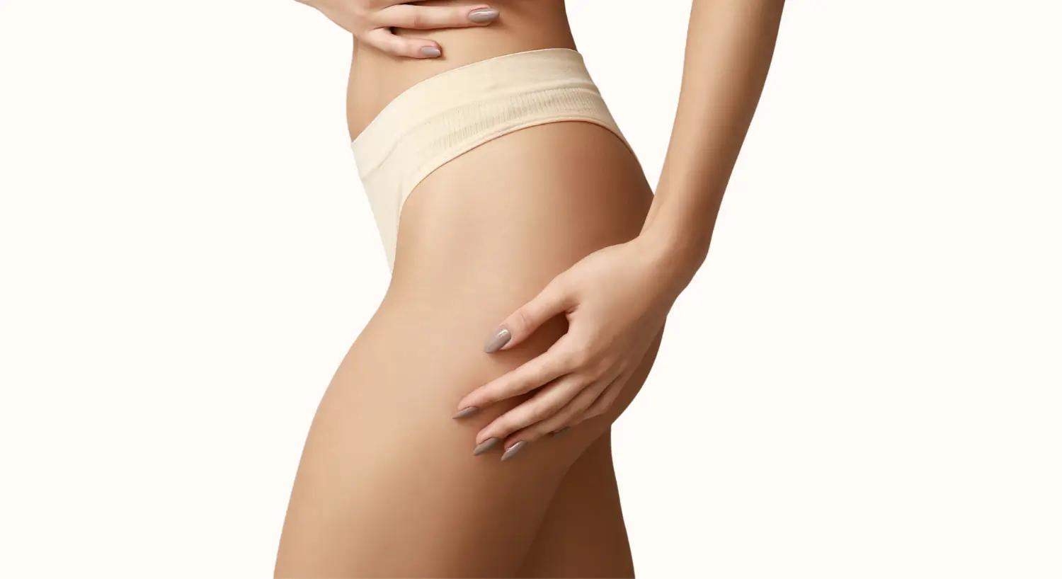 Model posing in athletic wear on a smooth surface.